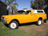 Ex military yellow four wheel drive Ford XY ute.