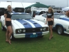 Ford Cobra flanked by scantily clad young ladies